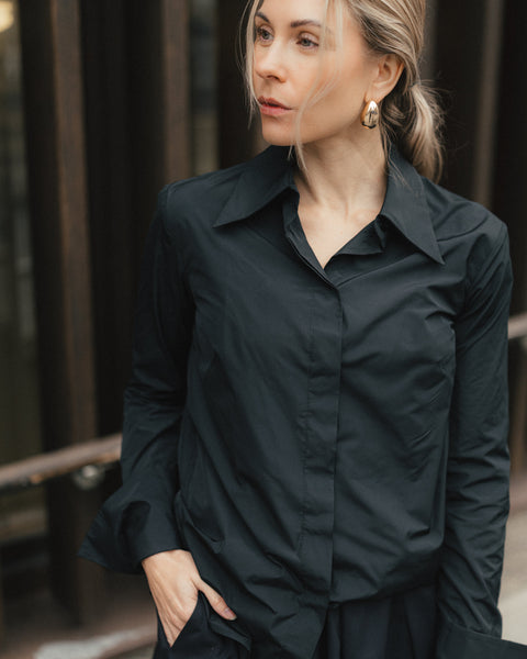 Woman wearing a black shirt with a blurred background
